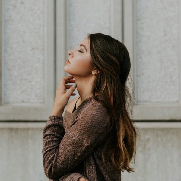 woman with eyes closed looking up